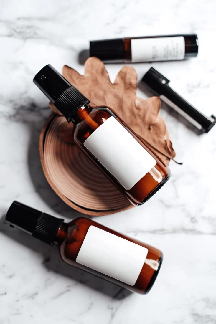 White labels wrapped around amber cosmetic bottles